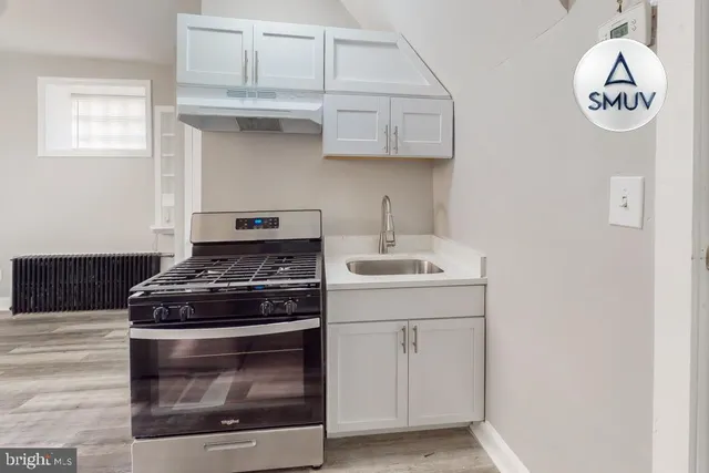 a view of a hallway with entryway and stairs