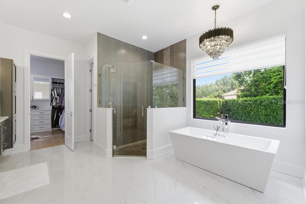 2829 Coastal Range Way Lutz, FL 33559 - Photo 35 of 64 a bathroom with a tub and a shower