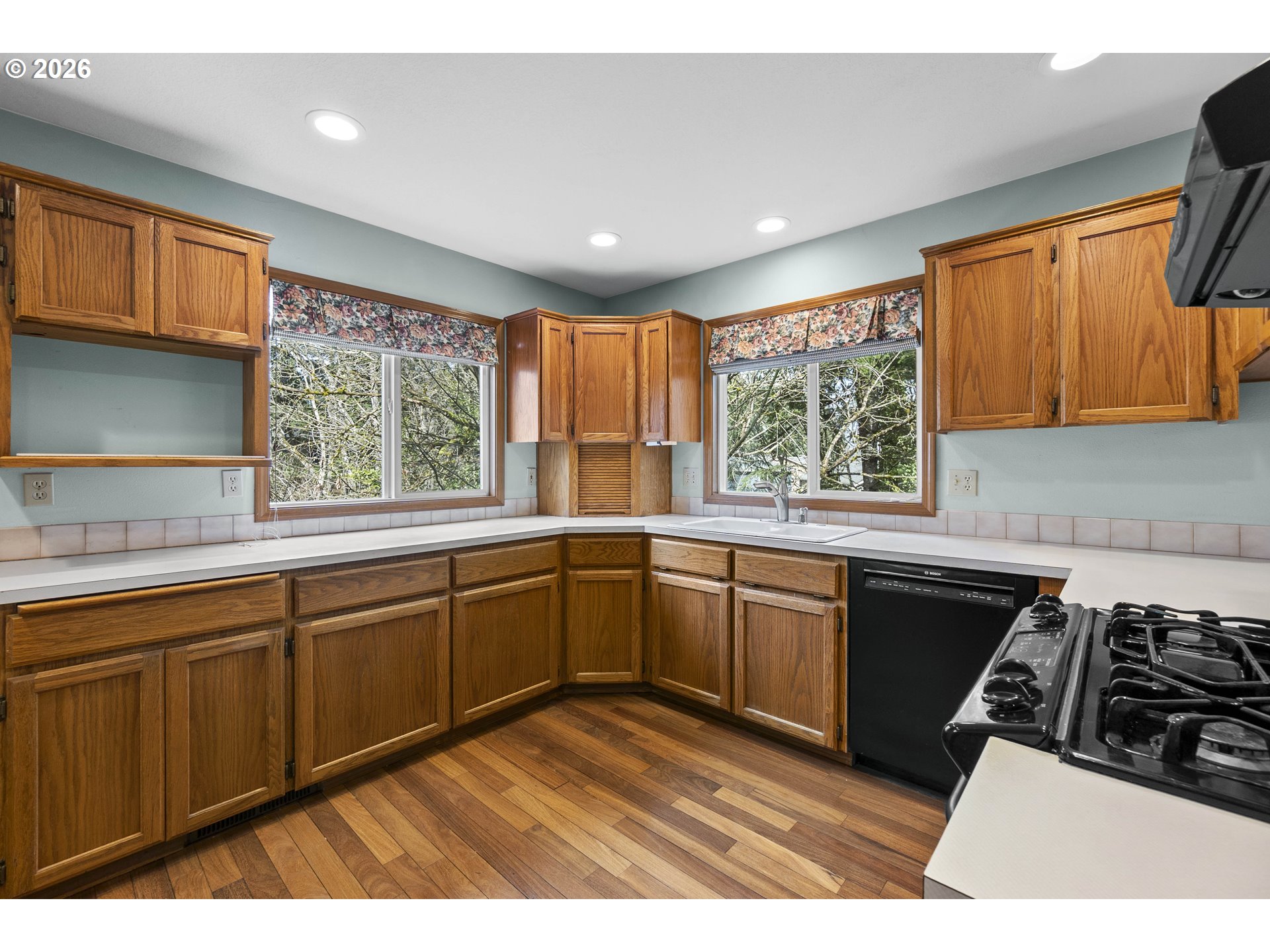 7574 Southwest 179th Place Beaverton, OR 97007 - Photo 12 of 48 a kitchen with a sink stove and cabinets