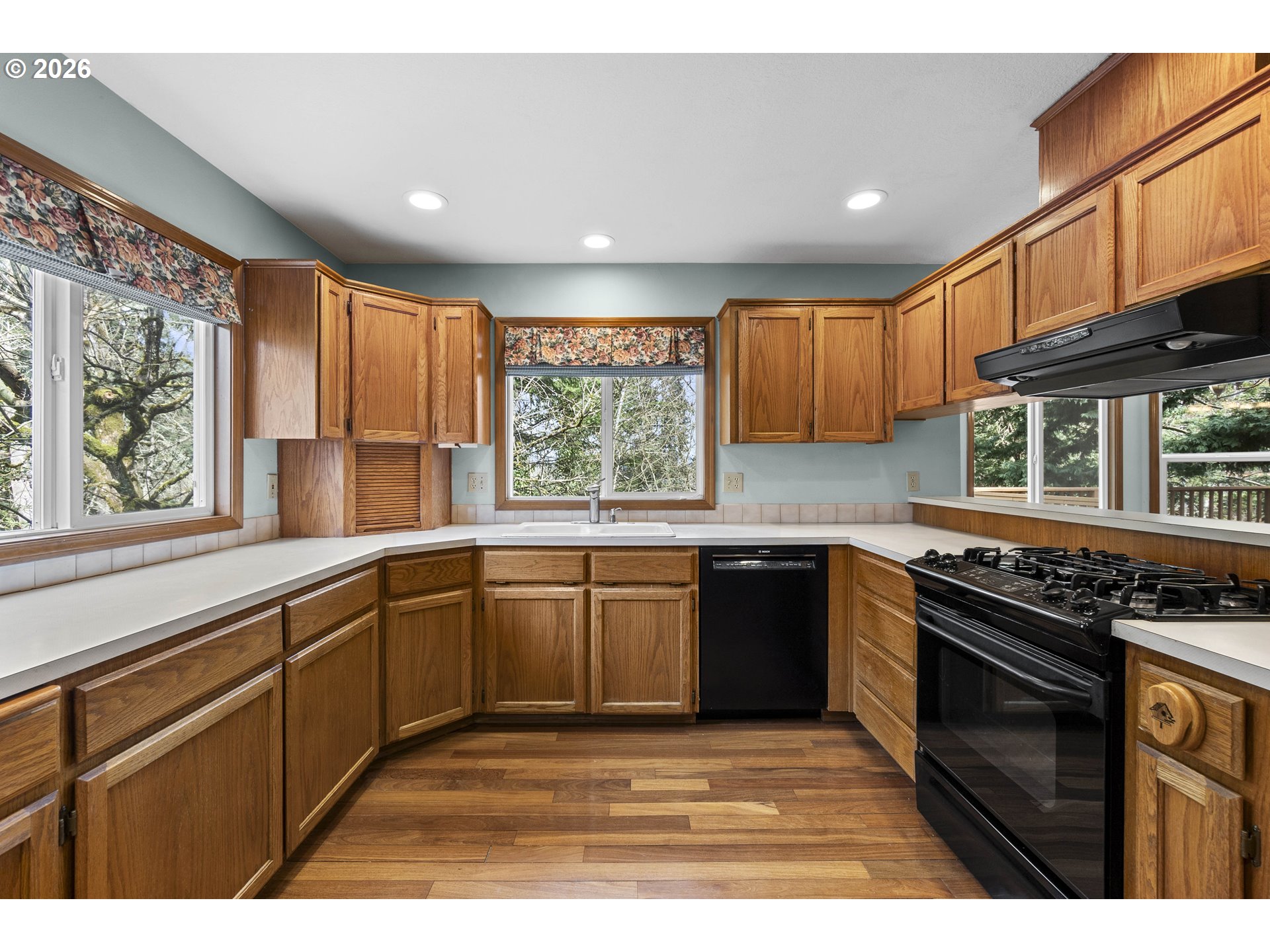 7574 Southwest 179th Place Beaverton, OR 97007 - Photo 13 of 48 a kitchen with stainless steel appliances granite countertop a stove sink and cabinets