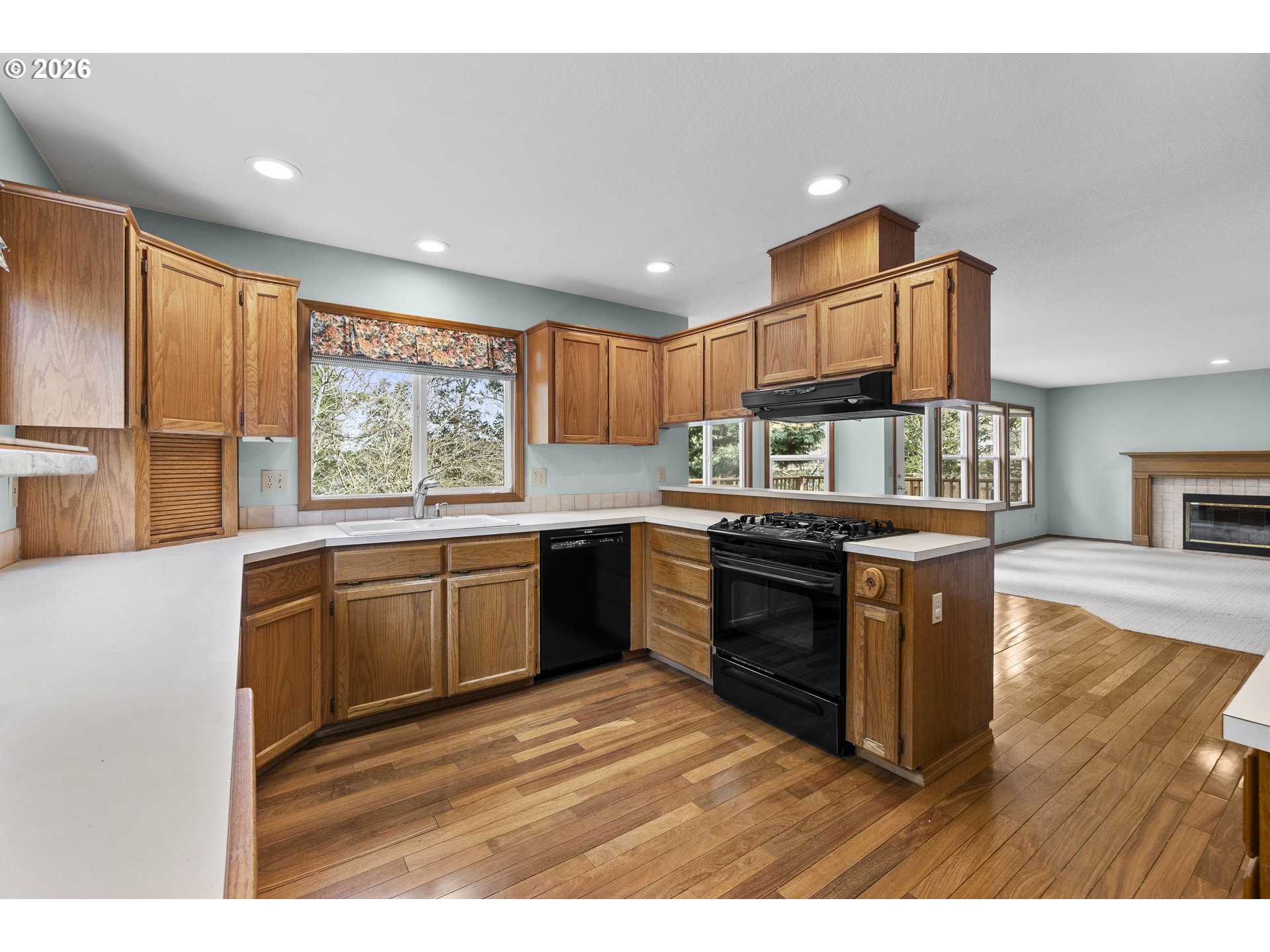 7574 Southwest 179th Place Beaverton, OR 97007 - Photo 14 of 48 a kitchen with kitchen island granite countertop white cabinets a counter top space and stainless steel appliances