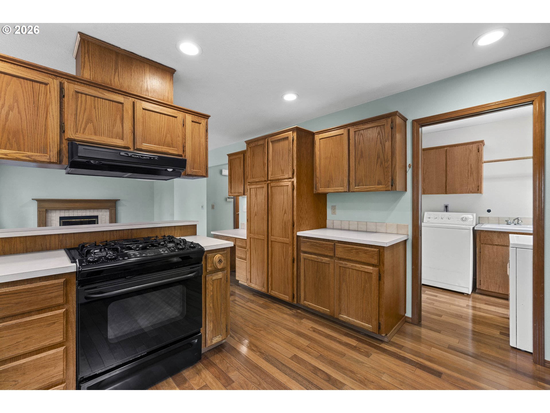 7574 Southwest 179th Place Beaverton, OR 97007 - Photo 15 of 48 a kitchen with a stove a sink and a refrigerator