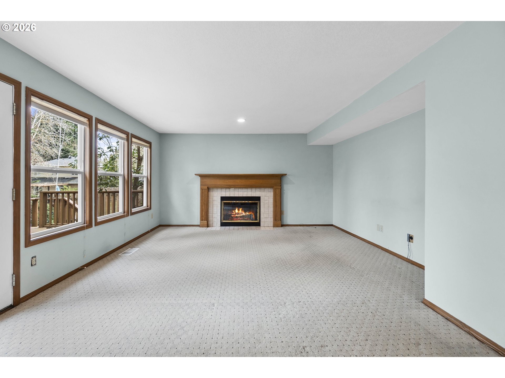 7574 Southwest 179th Place Beaverton, OR 97007 - Photo 17 of 48 a view of an empty room with a fireplace and a window
