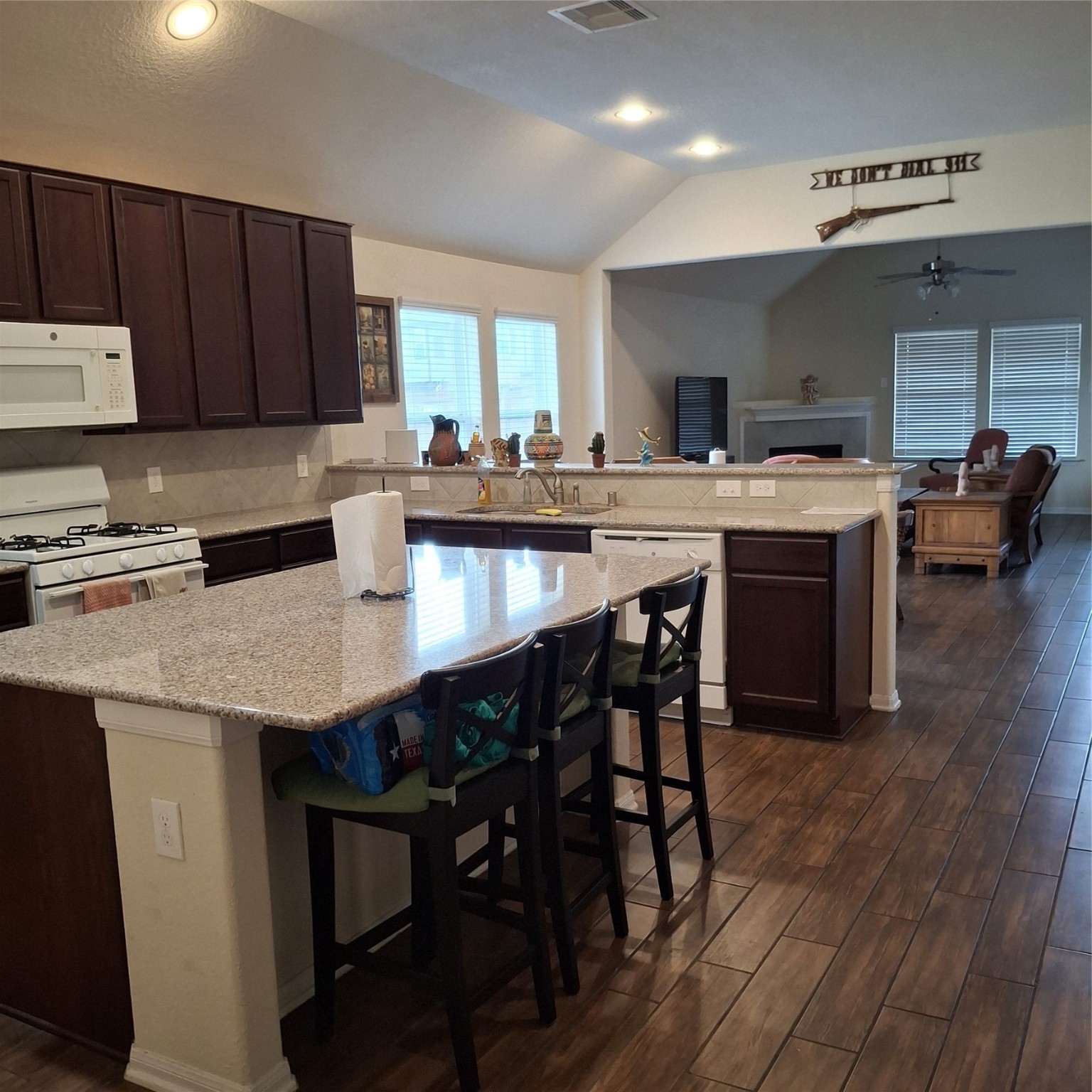 3034 Tandem Court Rosenberg, TX 77471 - Photo 6 of 27 a kitchen with granite countertop a table chairs sink and cabinets