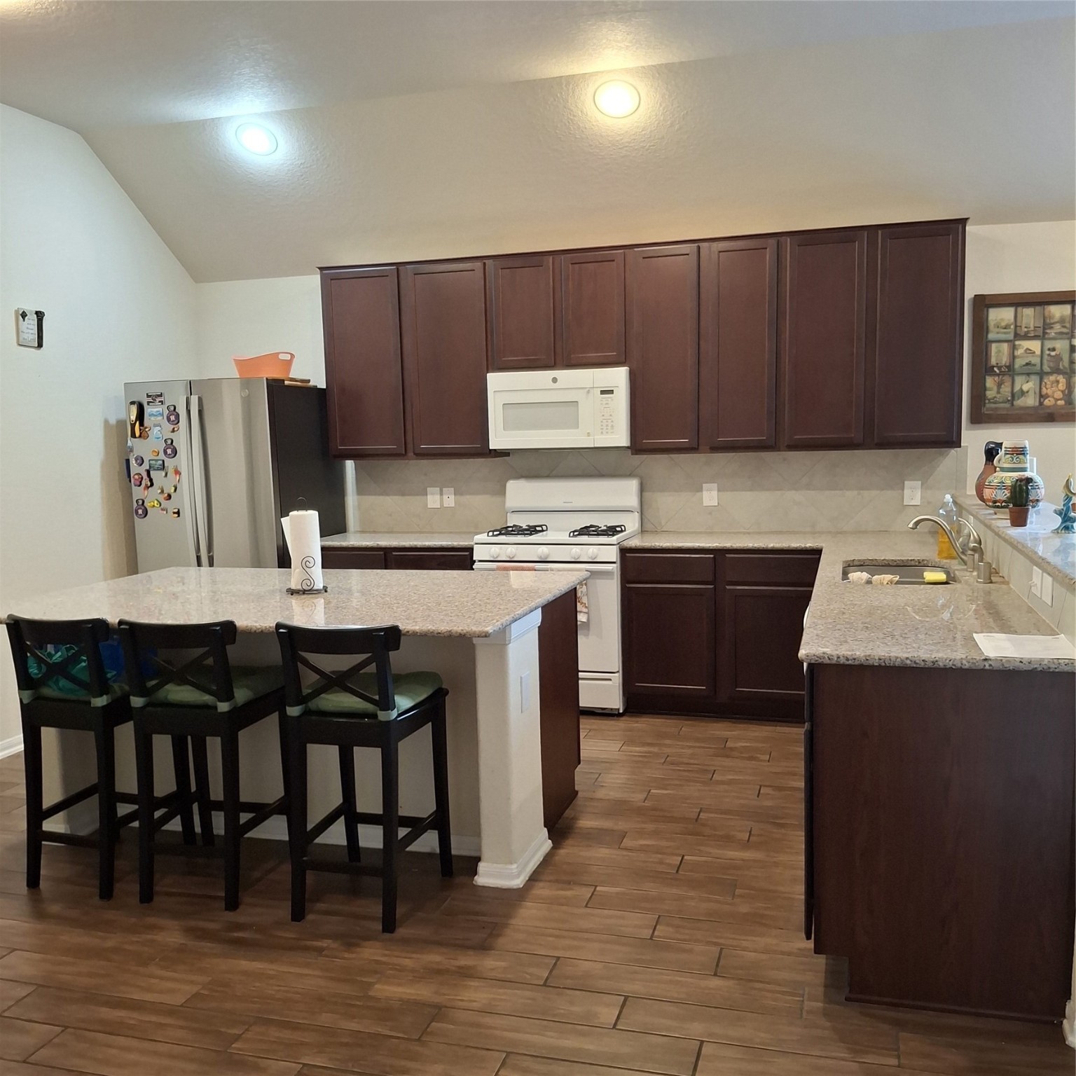 3034 Tandem Court Rosenberg, TX 77471 - Photo 7 of 27 a kitchen with a sink cabinets and wooden floor