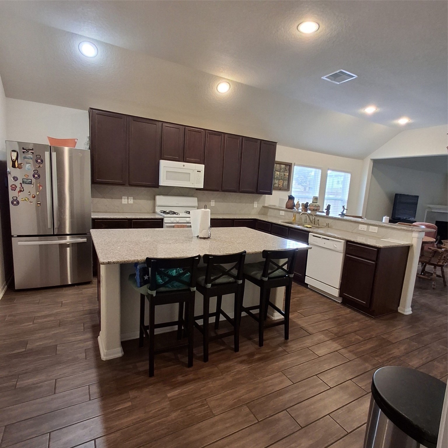 3034 Tandem Court Rosenberg, TX 77471 - Photo 8 of 27 a kitchen with stainless steel appliances a dining table chairs refrigerator and microwave
