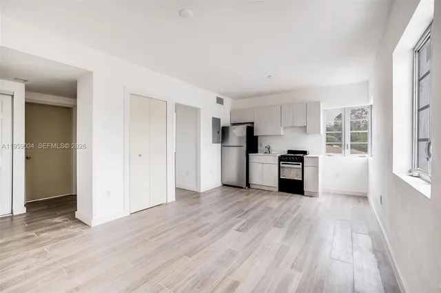 a kitchen with stainless steel appliances a refrigerator a stove a microwave and cabinets