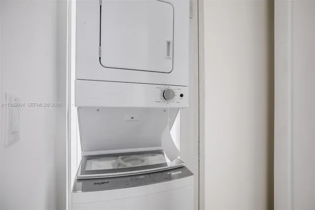 a kitchen with a refrigerator stove and wooden floor