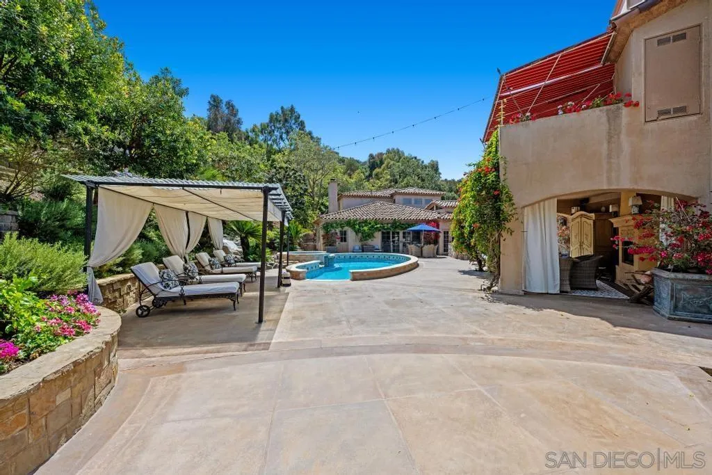 2643 Hidden Valley Road La Jolla, CA 92037 - Photo 12 of 61 a view of a patio with table and chairs potted plants with wooden fence
