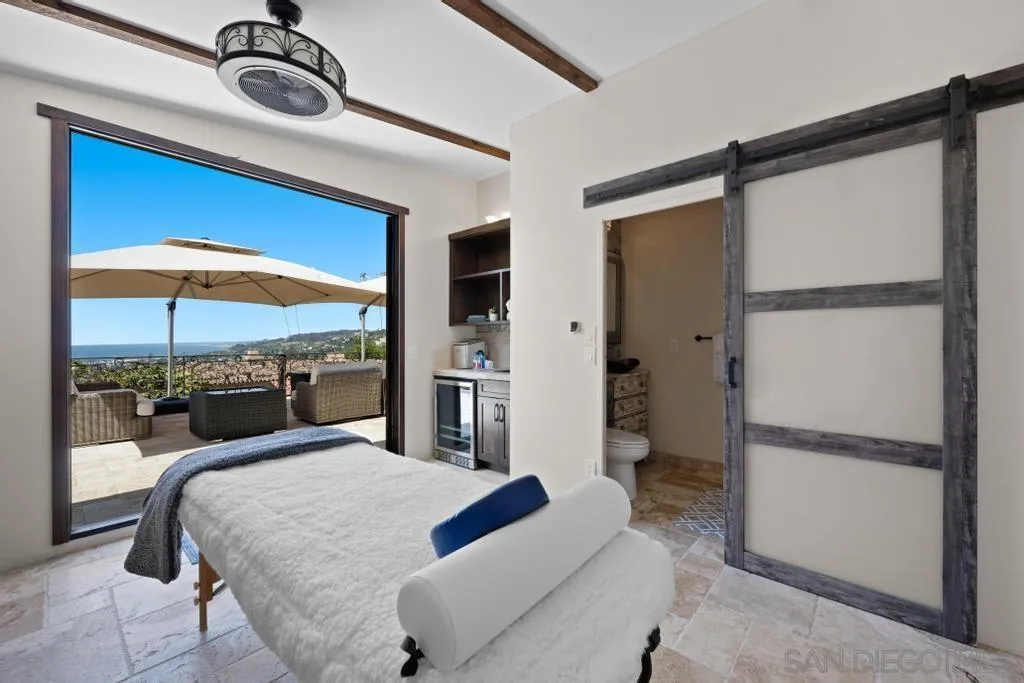 2643 Hidden Valley Road La Jolla, CA 92037 - Photo 17 of 61 a bedroom with a bed and a mirror