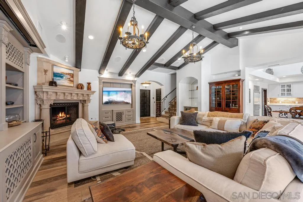 2643 Hidden Valley Road La Jolla, CA 92037 - Photo 22 of 61 a living room with furniture a fireplace and a chandelier
