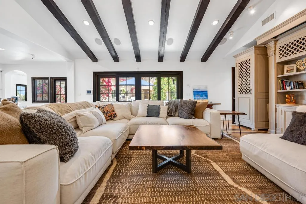 2643 Hidden Valley Road La Jolla, CA 92037 - Photo 23 of 61 a living room with furniture a rug and a large window