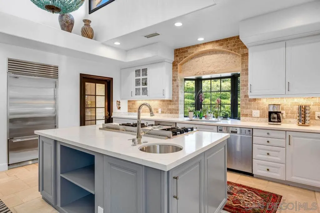 2643 Hidden Valley Road La Jolla, CA 92037 - Photo 28 of 61 a kitchen with sink stove and cabinets