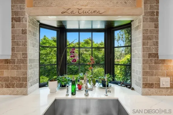 a bathroom with a granite countertop sink a mirror and shower