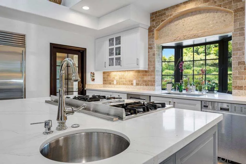 2643 Hidden Valley Road La Jolla, CA 92037 - Photo 30 of 61 a kitchen with a sink a counter and cabinets