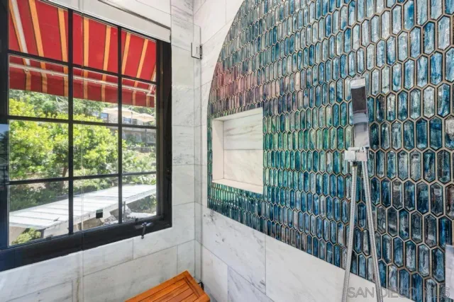 a bedroom with a large bed and a large window