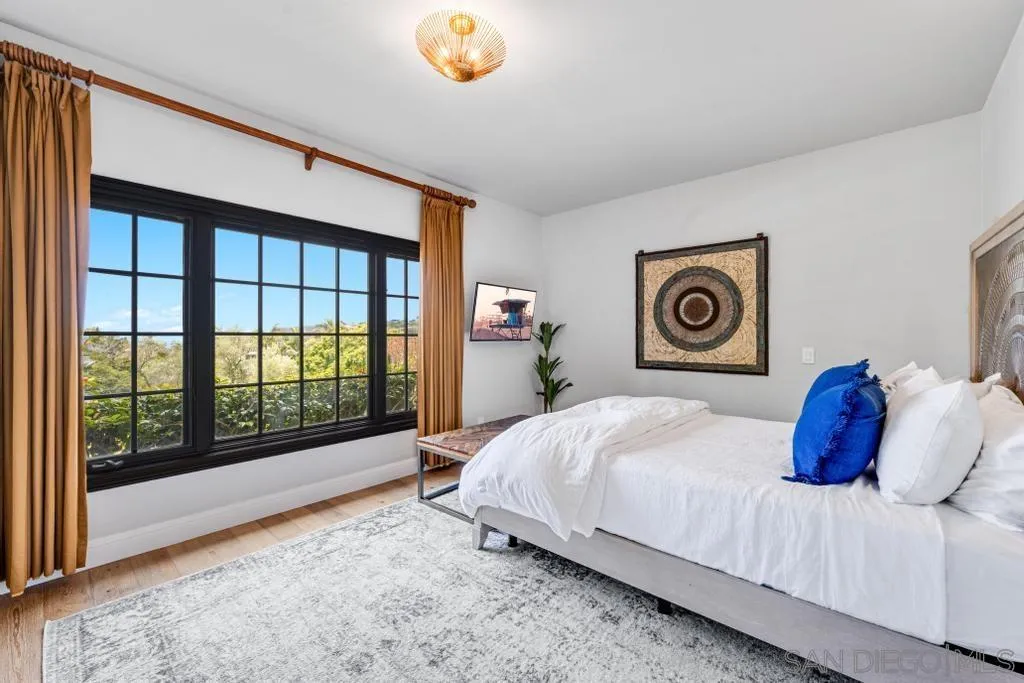 2643 Hidden Valley Road La Jolla, CA 92037 - Photo 49 of 61 a bedroom with a large bed and a large window