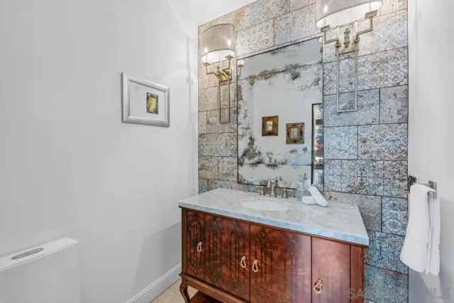 a view of a house with a yard and potted plants