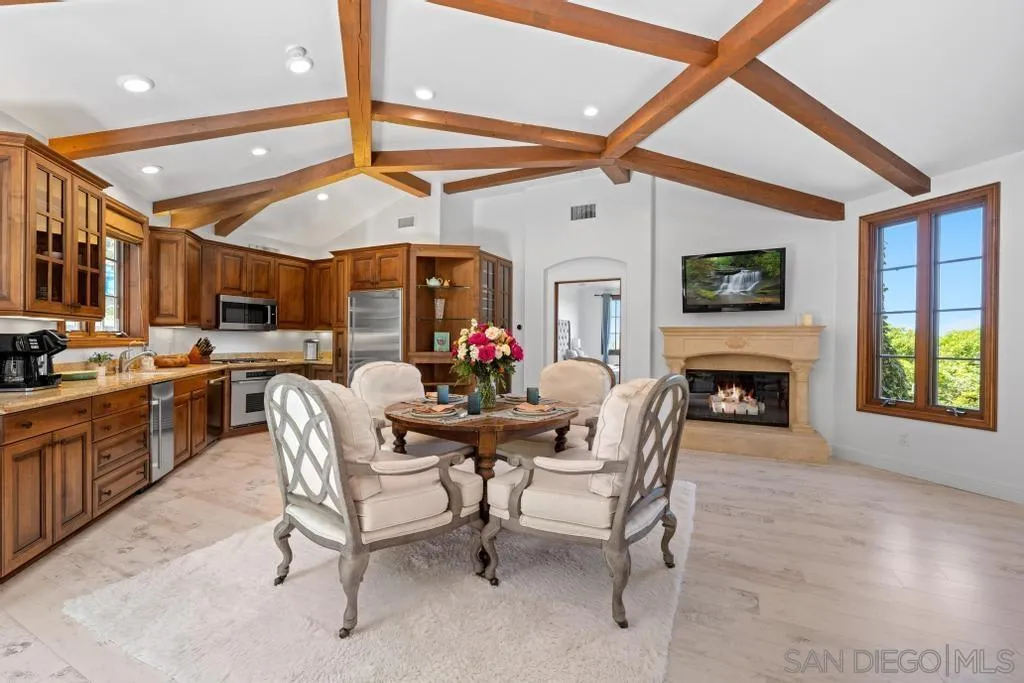 2643 Hidden Valley Road La Jolla, CA 92037 - Photo 56 of 61 a dining room with furniture a fireplace and a chandelier