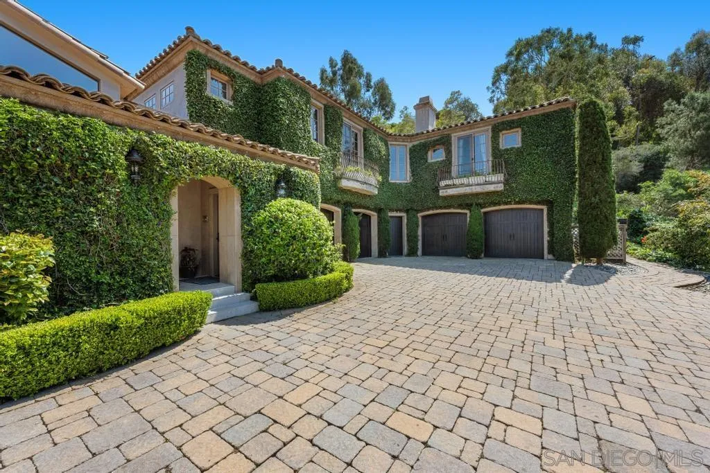 2643 Hidden Valley Road La Jolla, CA 92037 - Photo 7 of 61 a front view of a house with a yard and potted plants