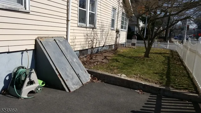 a view of a backyard with two chairs and a garage
