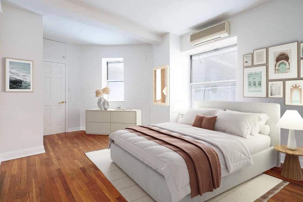 61 East 77th Street, Unit 3EF Manhattan, NY 10075 - Photo 3 of 12 a bedroom with a bed and a large window