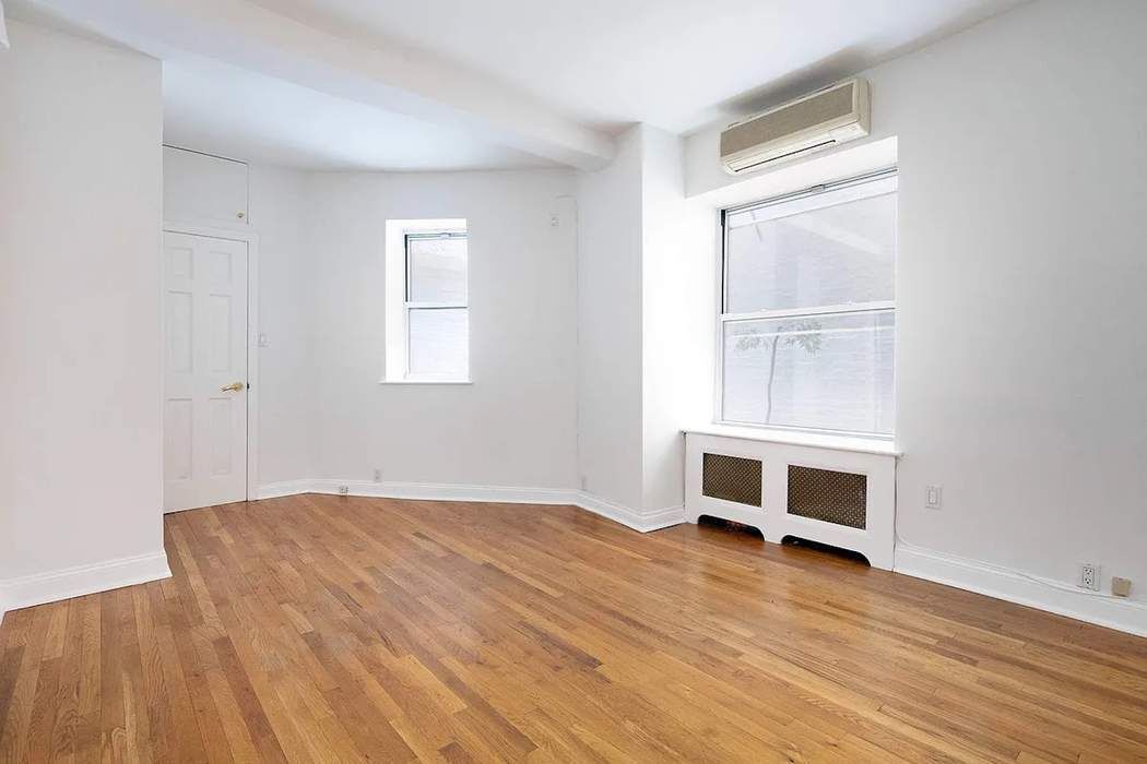 61 East 77th Street, Unit 3EF Manhattan, NY 10075 - Photo 4 of 12 a view of a room with wooden floor and window