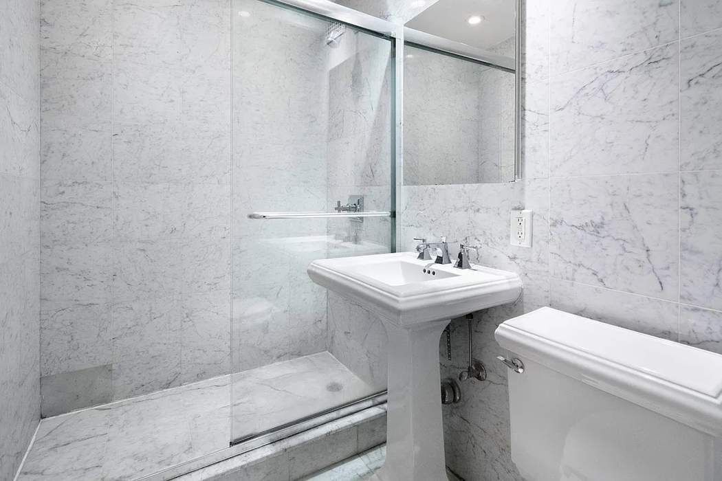 61 East 77th Street, Unit 3EF Manhattan, NY 10075 - Photo 5 of 12 a bathroom with a sink a toilet and shower