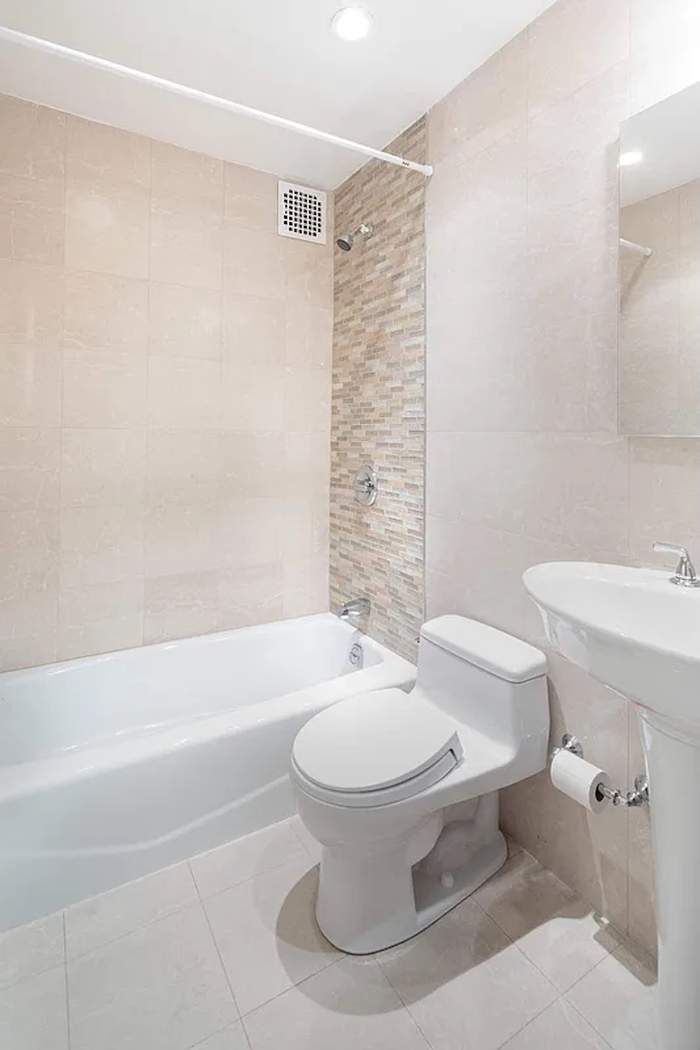 61 East 77th Street, Unit 3EF Manhattan, NY 10075 - Photo 8 of 12 a bathroom with a toilet and a bathtub
