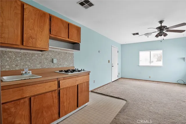 a kitchen with granite countertop cabinets and window