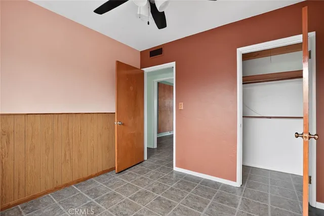 a bathroom with a granite countertop toilet a sink and a mirror
