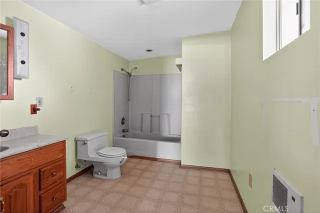 a bathroom with a sink mirror and a shower