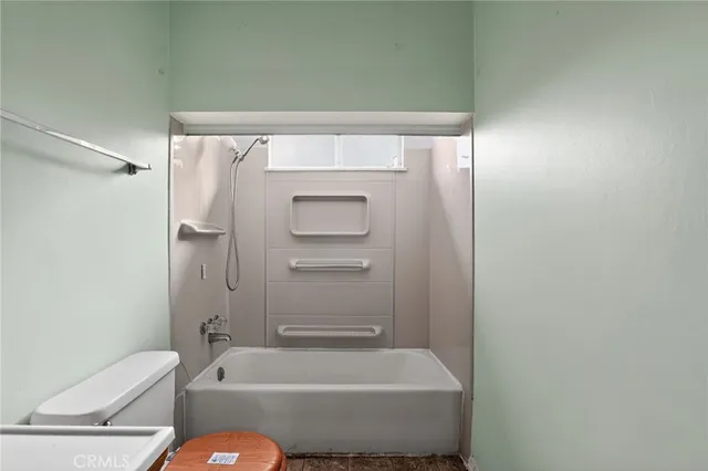 a view of a hallway with wooden floor and a hallway