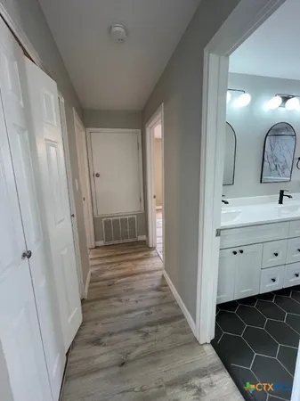 wooden floor in an empty room with a window