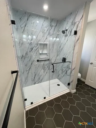 a bathroom with a toilet and a shower