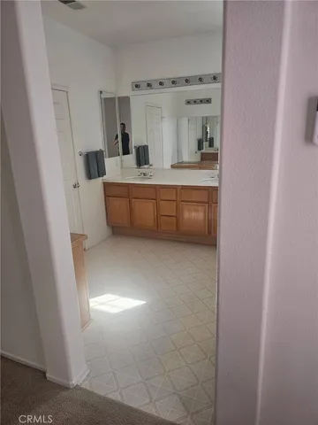 a bathroom with a double vanity sink and mirror