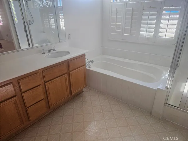 a bath room with a sink and a bath tub