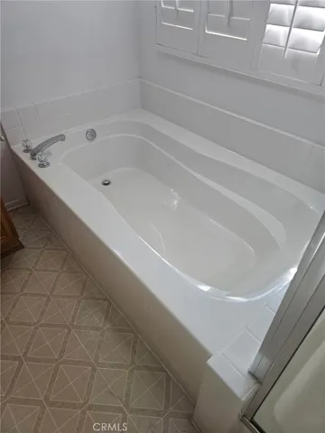 a bathroom with a granite countertop bathtub and sink