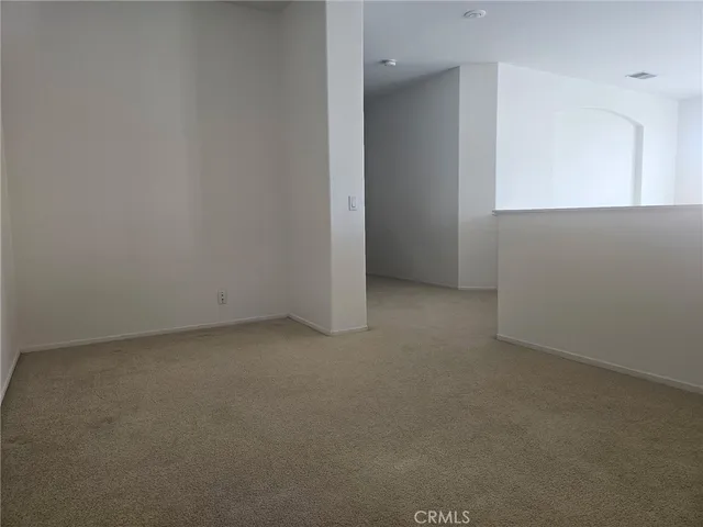 a spacious bedroom with a bed and window