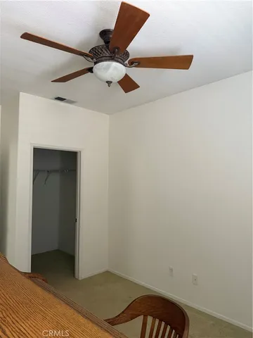 a view of a patio with chairs and table in backyard