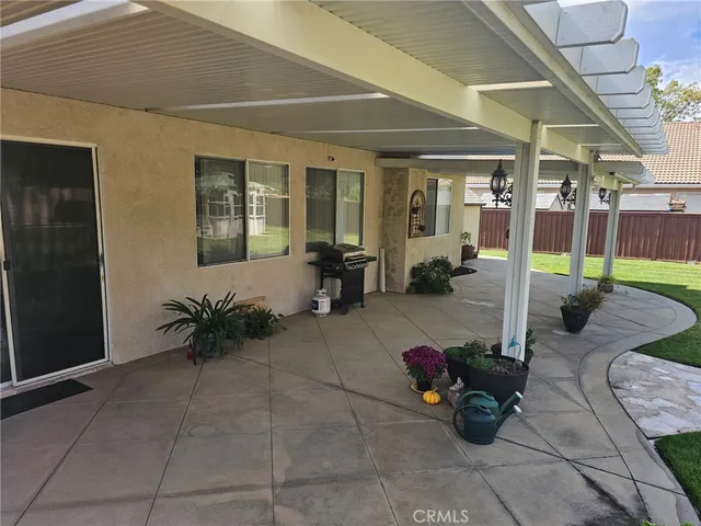a view of a house with a yard and a patio