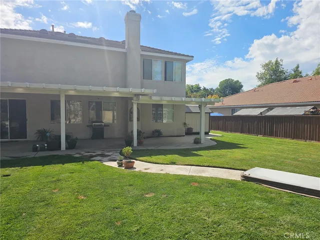a view of a house with a yard patio and a patio