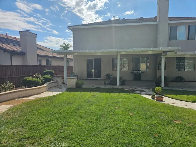 a view of a house with backyard porch and sitting area