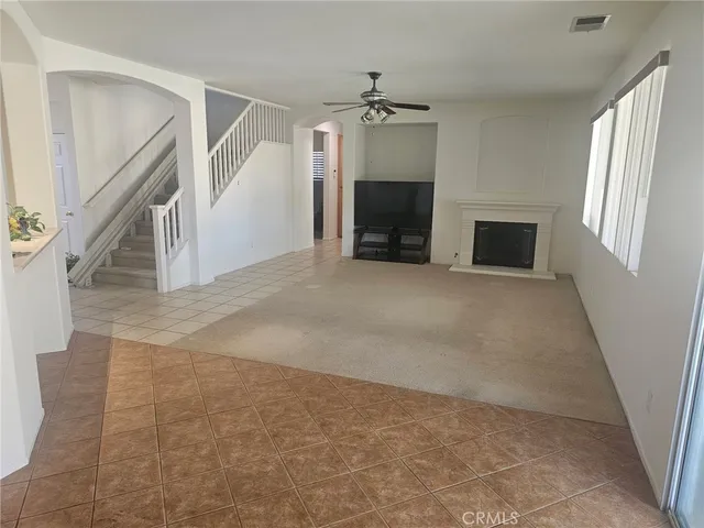 a view of empty room with fireplace and stairs
