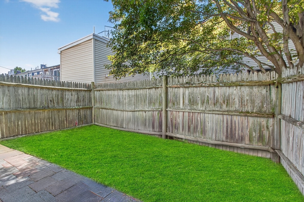 14 Wall Street Boston, MA 02129 - Photo 1 of 18 a view of a backyard with a small cabin and wooden fence