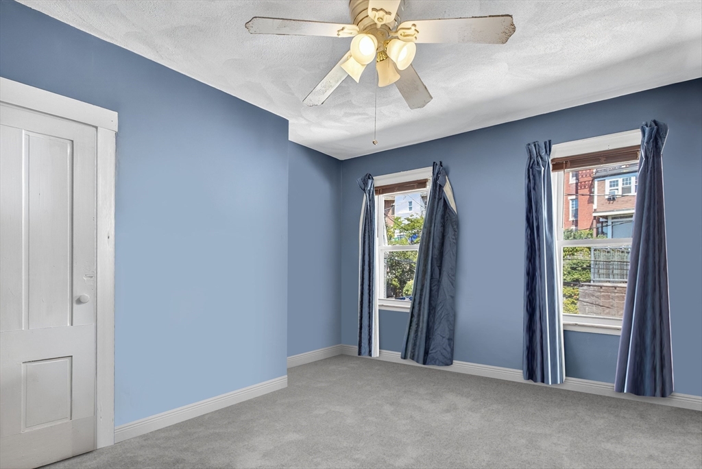 14 Wall Street Boston, MA 02129 - Photo 11 of 18 an empty room with windows and fan
