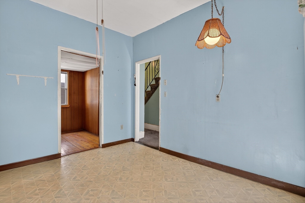 14 Wall Street Boston, MA 02129 - Photo 14 of 18 an empty room with a mirror and a chandelier