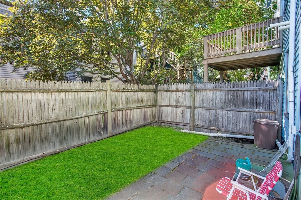 14 Wall Street Boston, MA 02129 - Photo 2 of 18 a view of a backyard with a small cabin and a wooden fence
