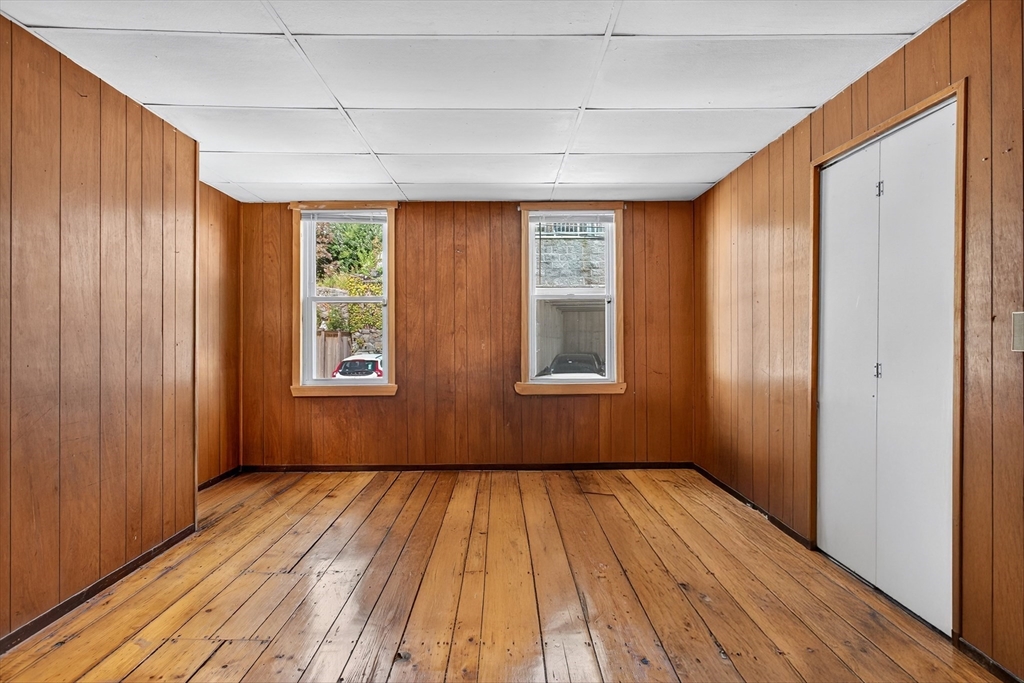 14 Wall Street Boston, MA 02129 - Photo 5 of 18 a view of empty room with wooden floor and fan