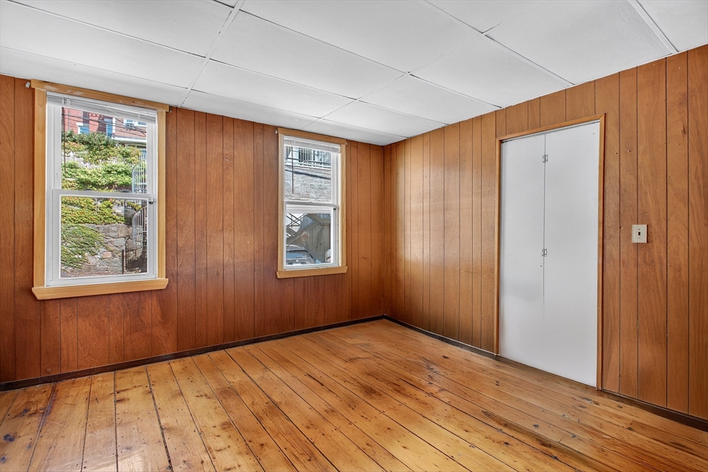 14 Wall Street Boston, MA 02129 - Photo 6 of 18 a view of an empty room with wooden floor and a window